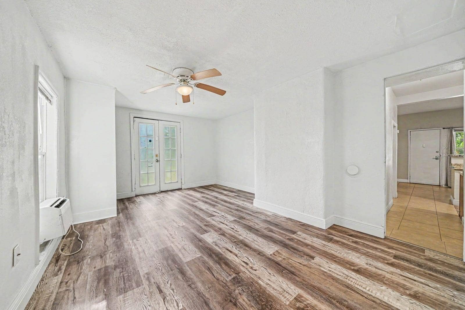 1015 S PENINSULA DRIVE, #1,2, Daytona Beach, FL 32118 Spacious Living Area with Wood Floors, French Doors & Ceiling Fan