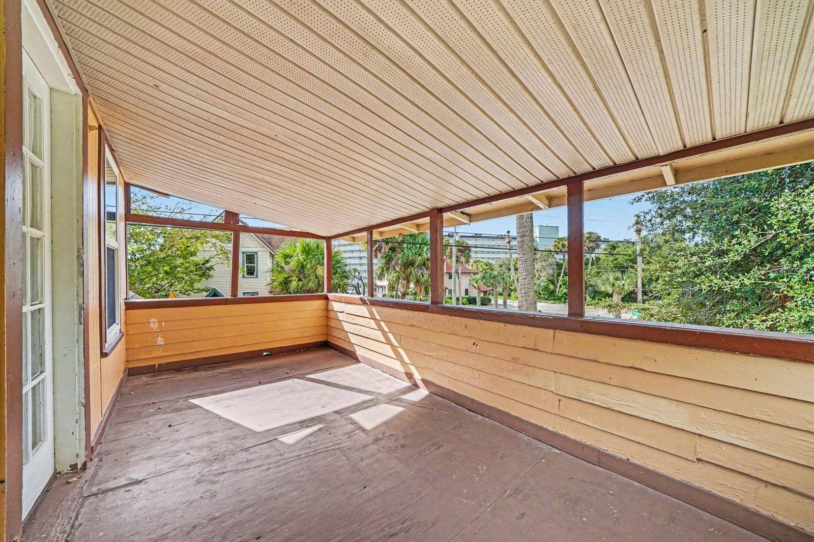 1015 S PENINSULA DRIVE, #1,2, Daytona Beach, FL 32118 Screened Patio Area with Metal Roof Covering & Garden Views