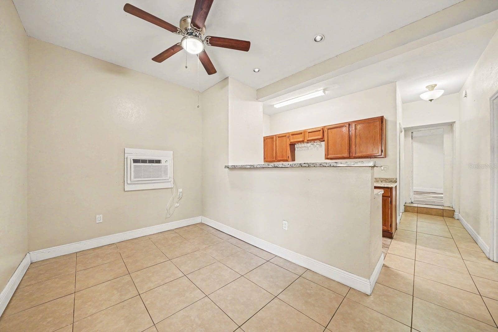 1015 S PENINSULA DRIVE, #1,2, Daytona Beach, FL 32118 Spacious Dining Area With Kitchen Cabinets & Ceiling Fan