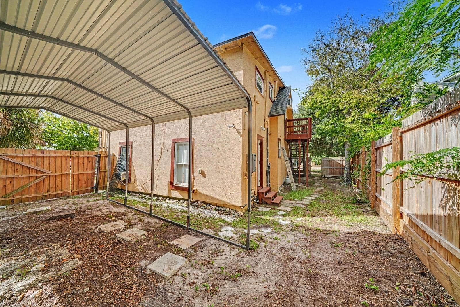 1015 S PENINSULA DRIVE, #1,2, Daytona Beach, FL 32118 Rear Yard with Carport & Fenced Landscaping Around Home