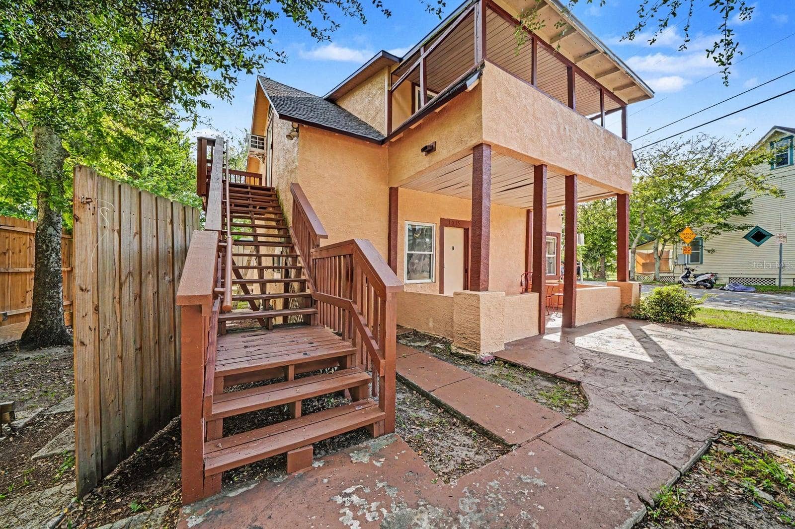 1015 S PENINSULA DRIVE, #1,2, Daytona Beach, FL 32118 Elevated Home With Red Wooden Stairs & Ground-Level Access
