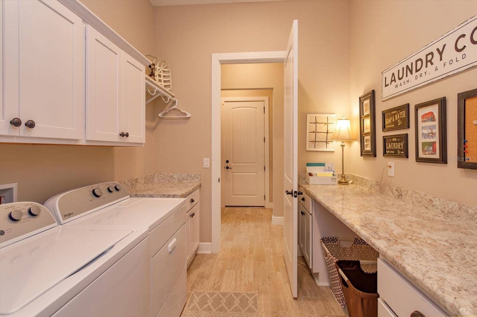 5663 SW 92ND AVENUE ROAD, Ocala, FL 34481 From the Closet or Hallway you can access the Laundry Area with Ample Storage and Countertops for Folding Laundry, Crafts or Projects.
