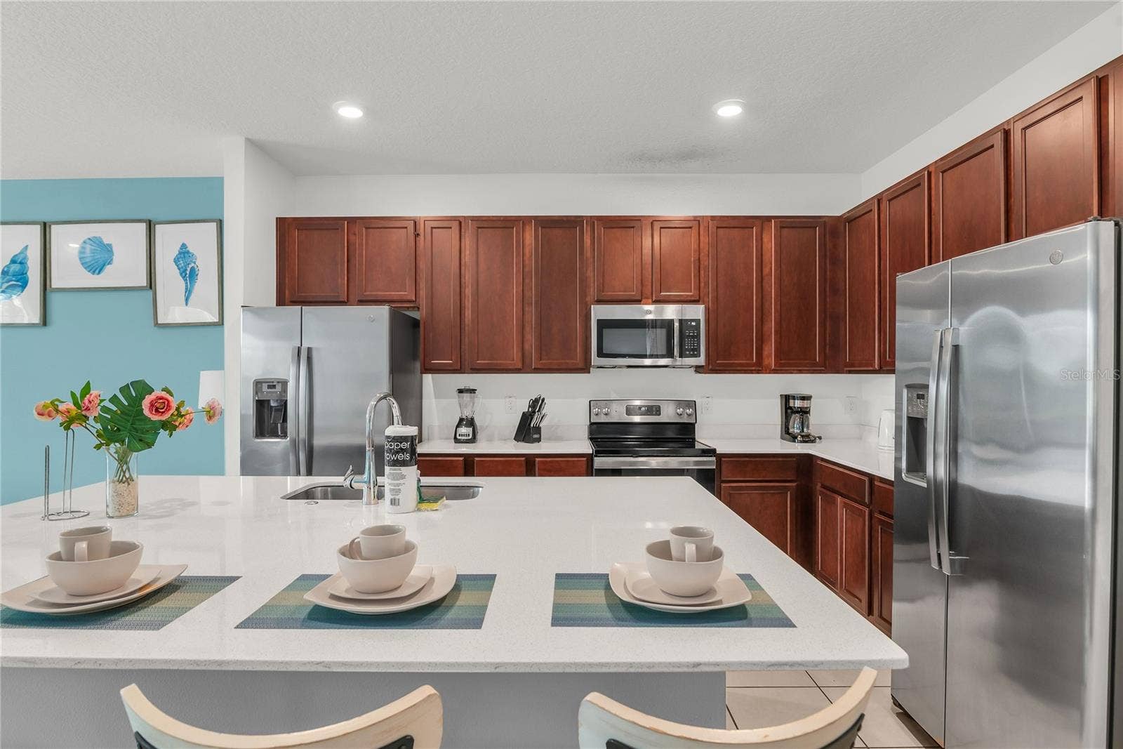 2576 SHANTI DRIVE, Kissimmee, FL 34746 Kitchen with double refrigerator and stainless steel appliances
