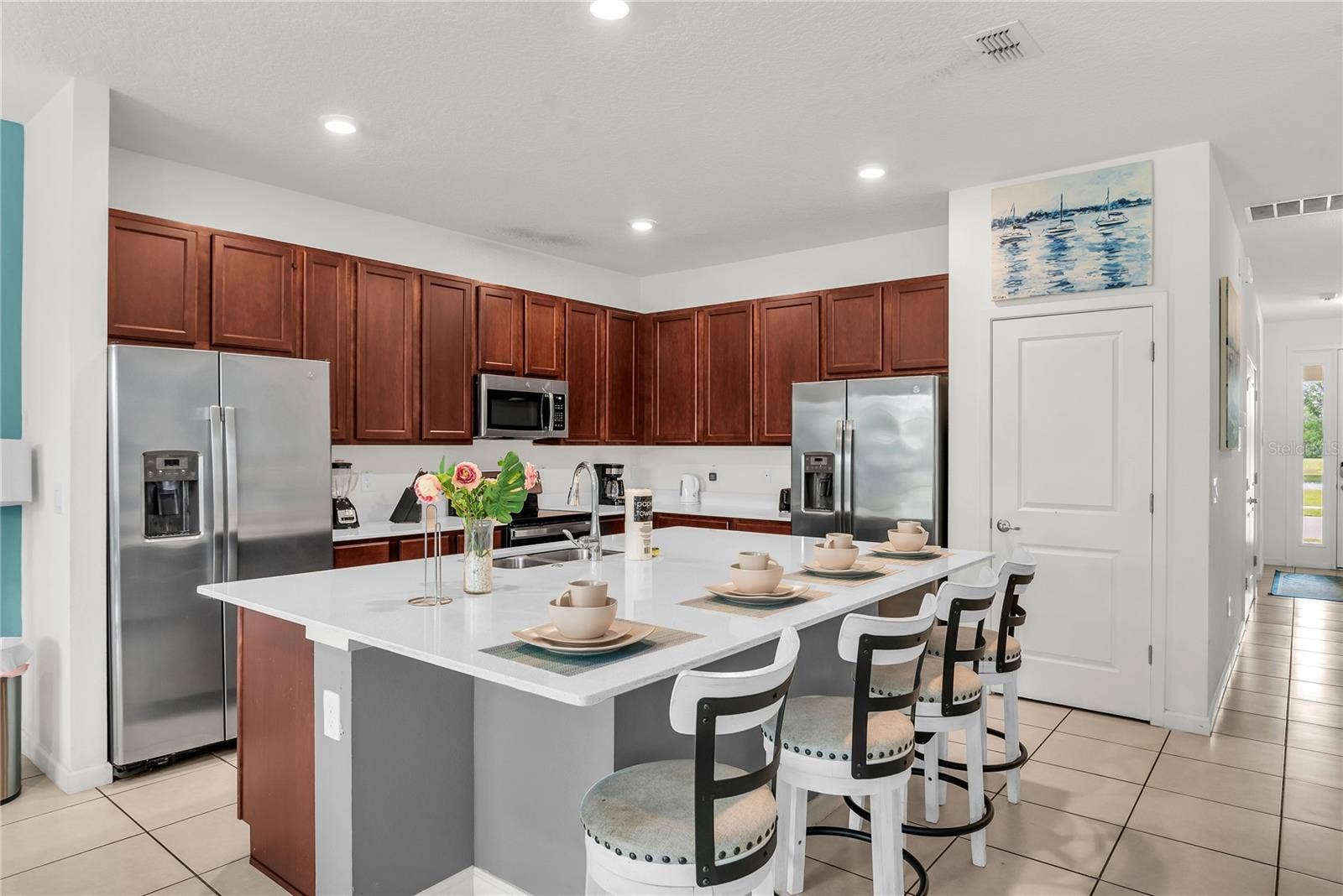 2576 SHANTI DRIVE, Kissimmee, FL 34746 Kitchen with double refrigerator and stainless steel appliances