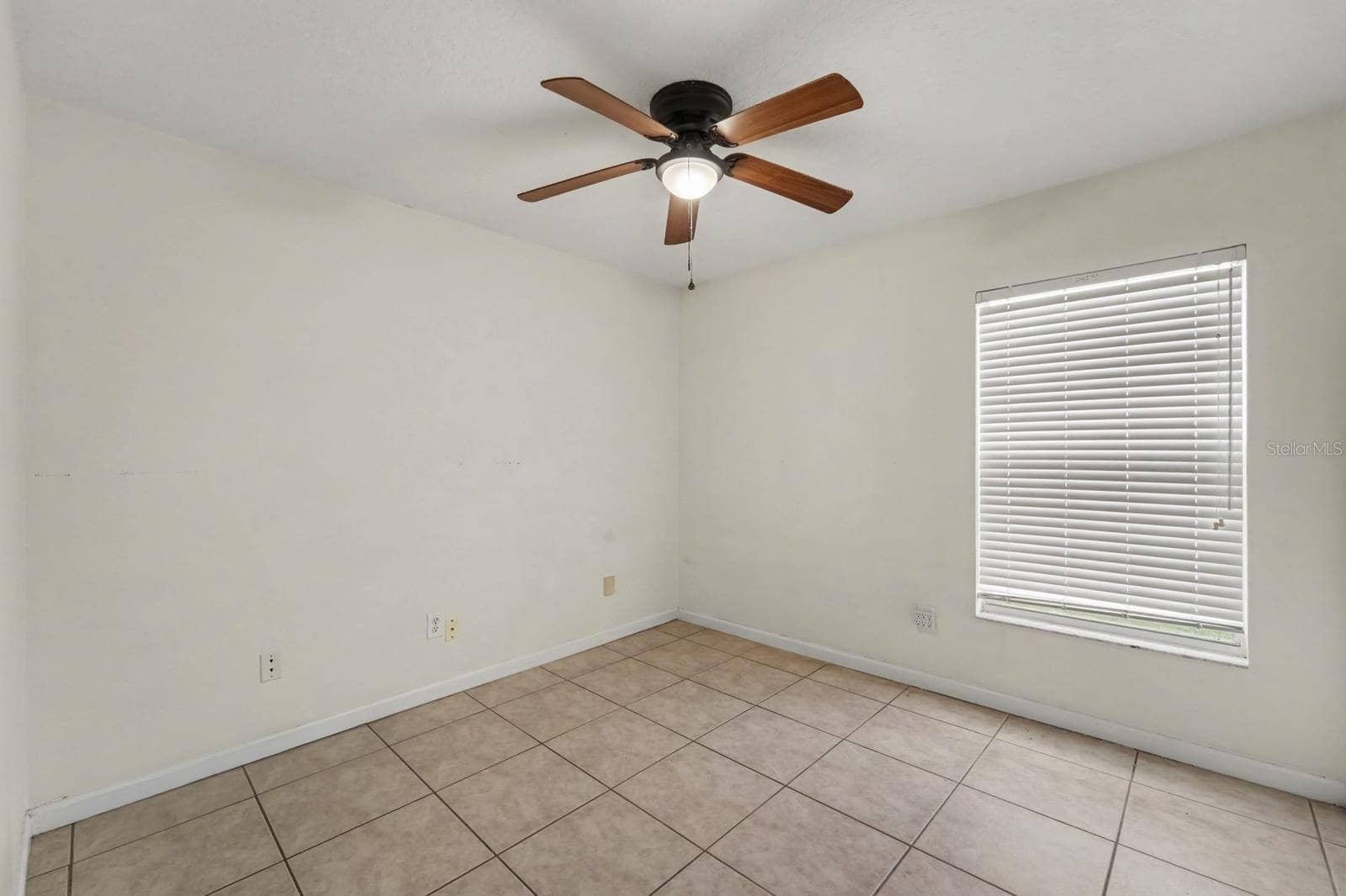 10913 BUCKWATER COURT, Orlando, FL 32817 Spacious Bedroom with Ceiling Fan, Large Window & Neutral Color Palette