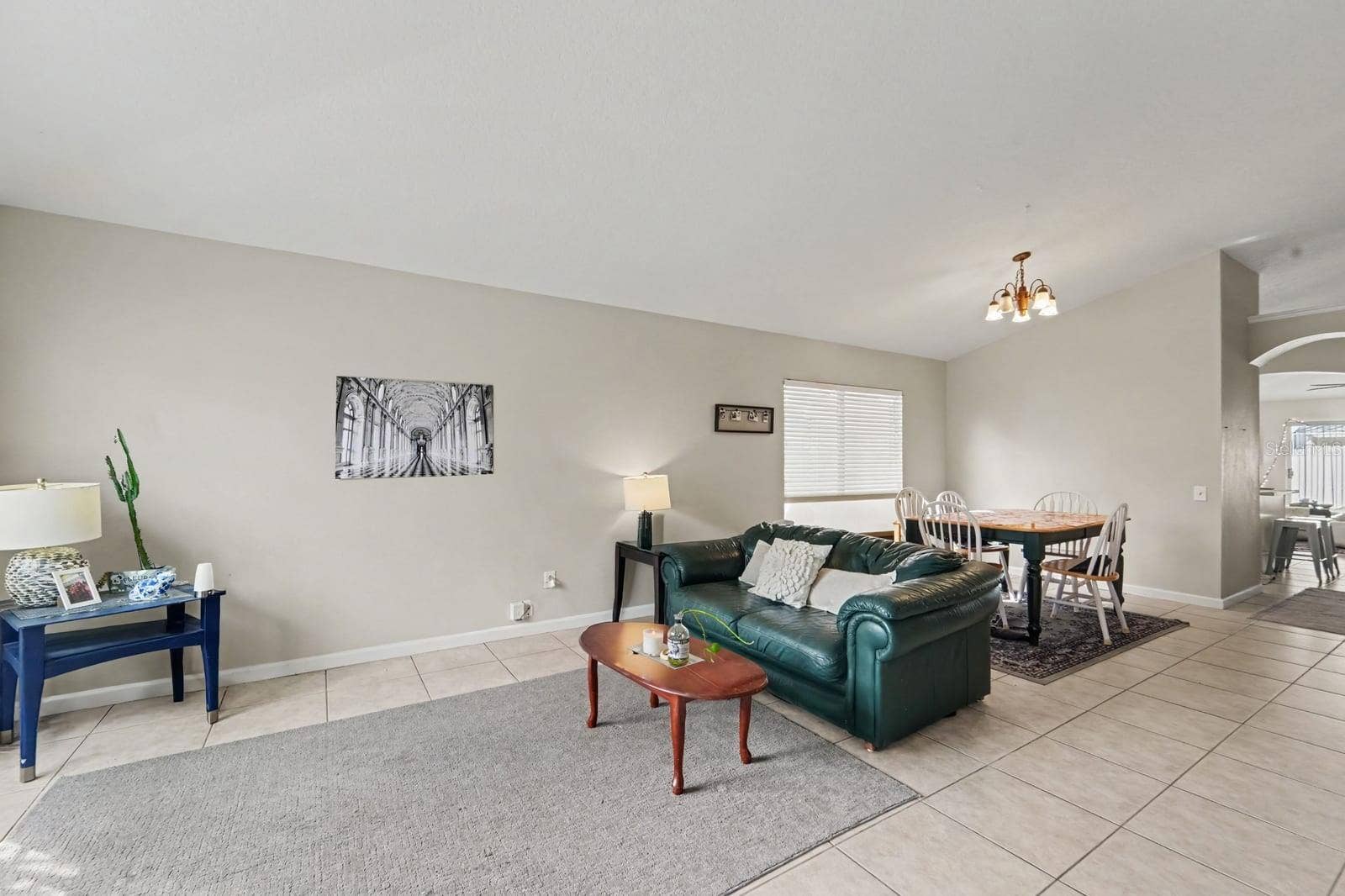 10913 BUCKWATER COURT, Orlando, FL 32817 Open Living Areas with Tile Floors, Wood Coffee Table & Abundant Natural Light