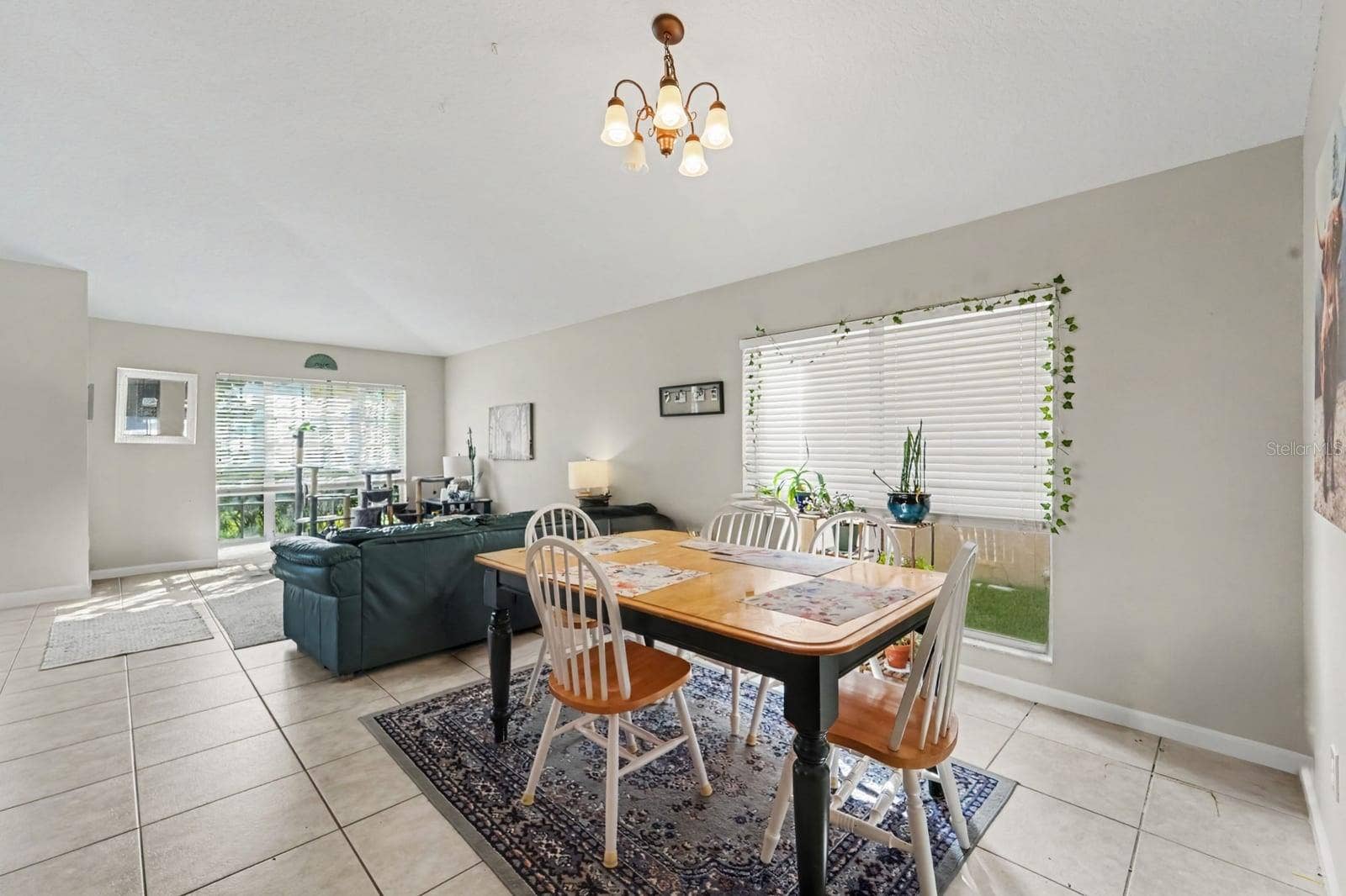 10913 BUCKWATER COURT, Orlando, FL 32817 Dining room with drop chandelier and views into adjacent living areas