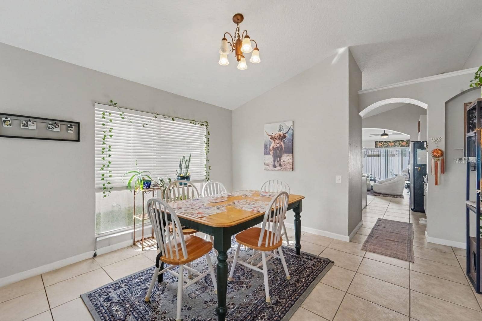 10913 BUCKWATER COURT, Orlando, FL 32817 Dining area features arched doorway connecting to kitchen and family spaces