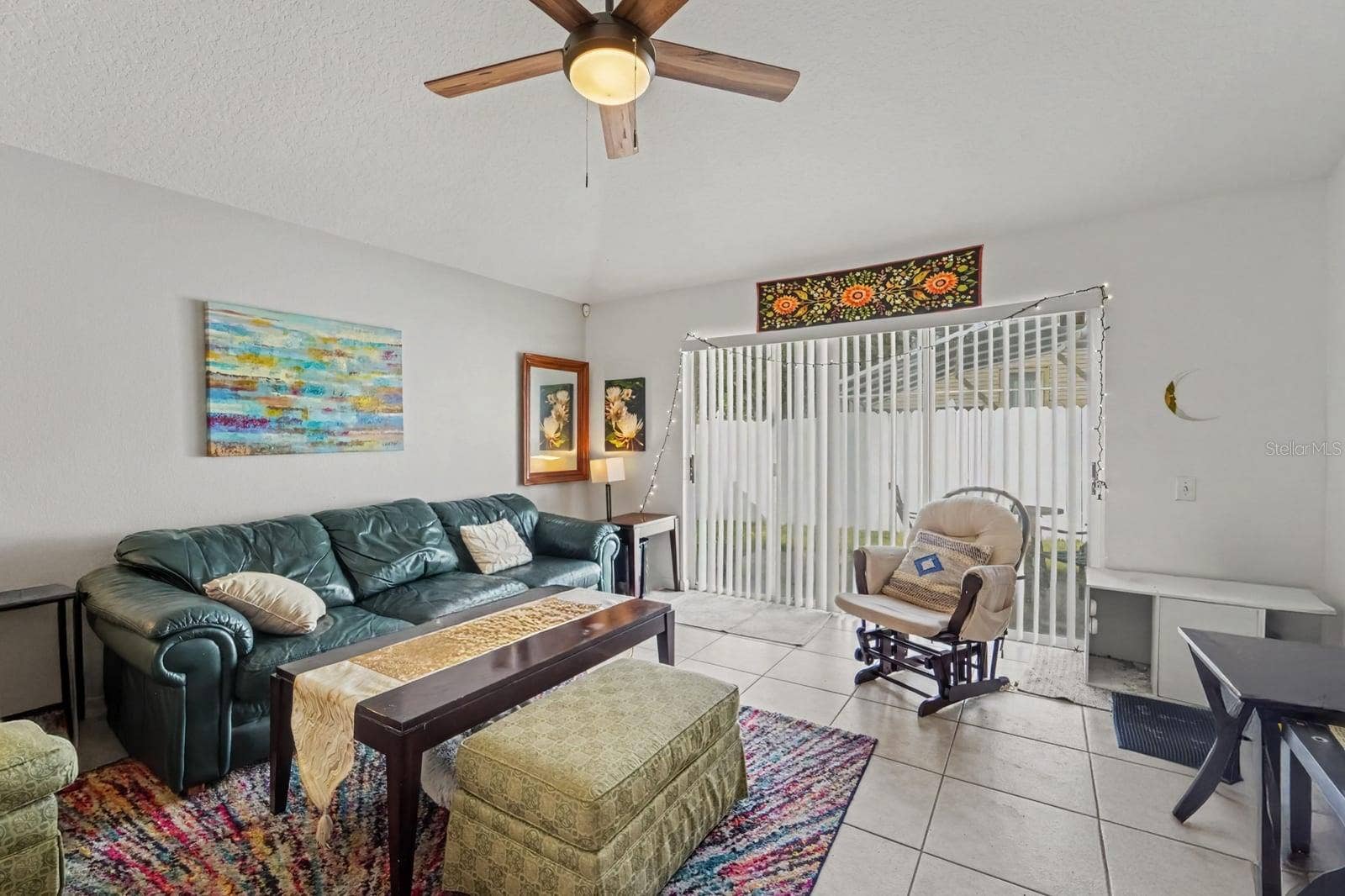 10913 BUCKWATER COURT, Orlando, FL 32817 Open-concept living space with tile flooring and direct access to outdoor area