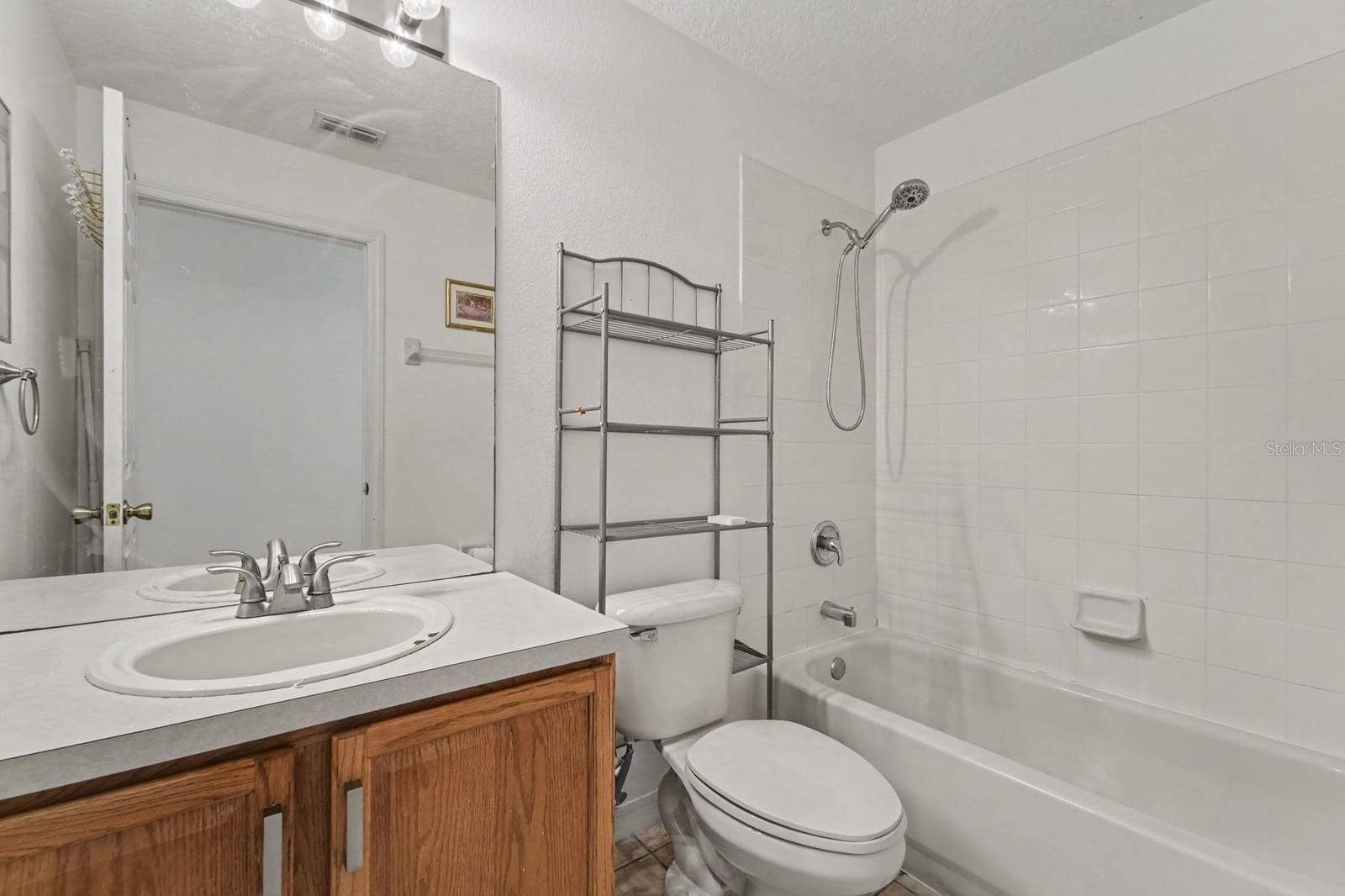 10913 BUCKWATER COURT, Orlando, FL 32817 Luxurious Master Bath with Dual Vanity, Garden Tub, Separate Shower, and Decorative Details