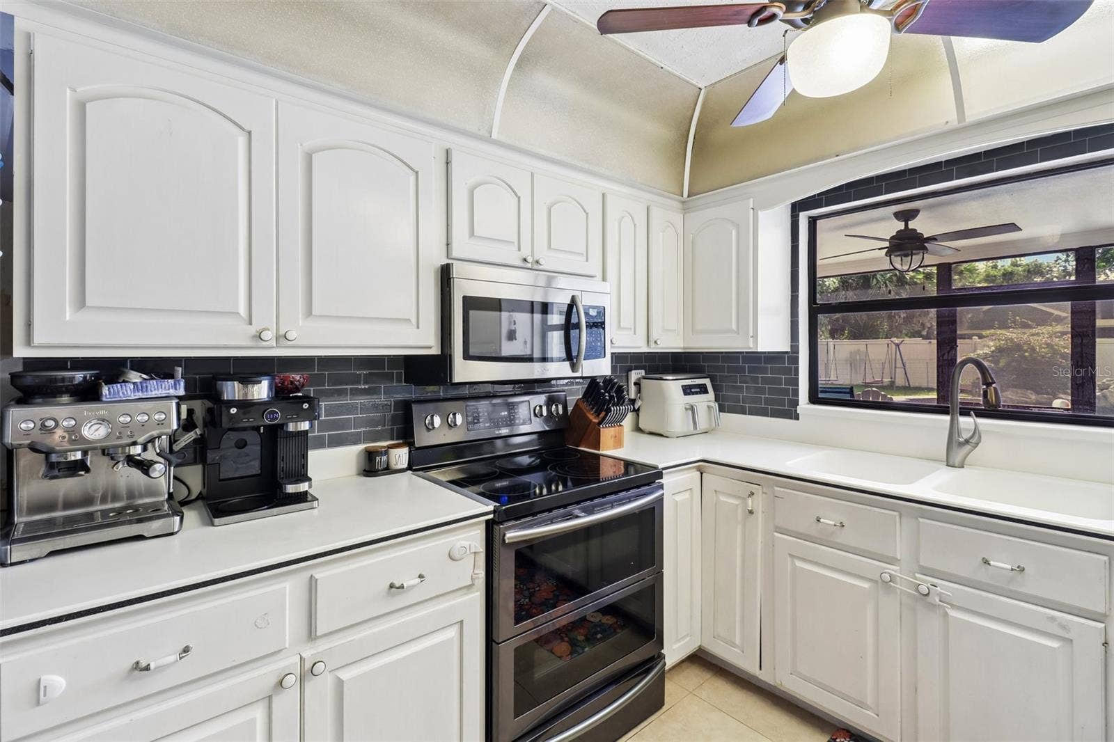 206 HARROGATE PLACE, Longwood, FL 32779 Stainless steel appliances, tiled backsplash.
