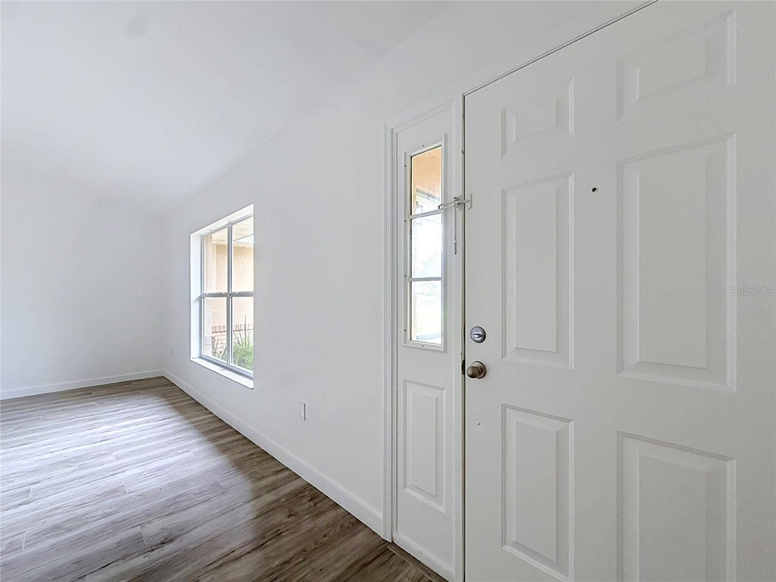 11 CARNATION COURT E, Homosassa, FL 34446 Step inside to natural light and wood-look flooring.