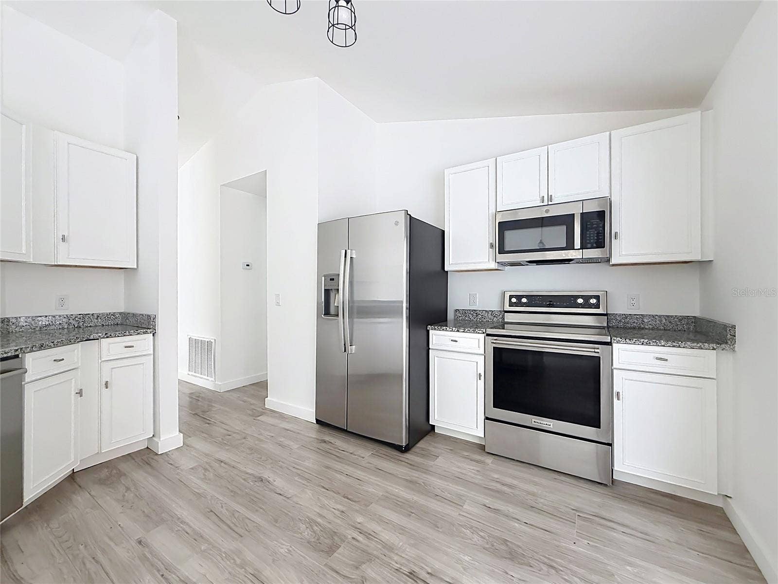 11 CARNATION COURT E, Homosassa, FL 34446 Stainless steel appliances elevate the bright kitchen.