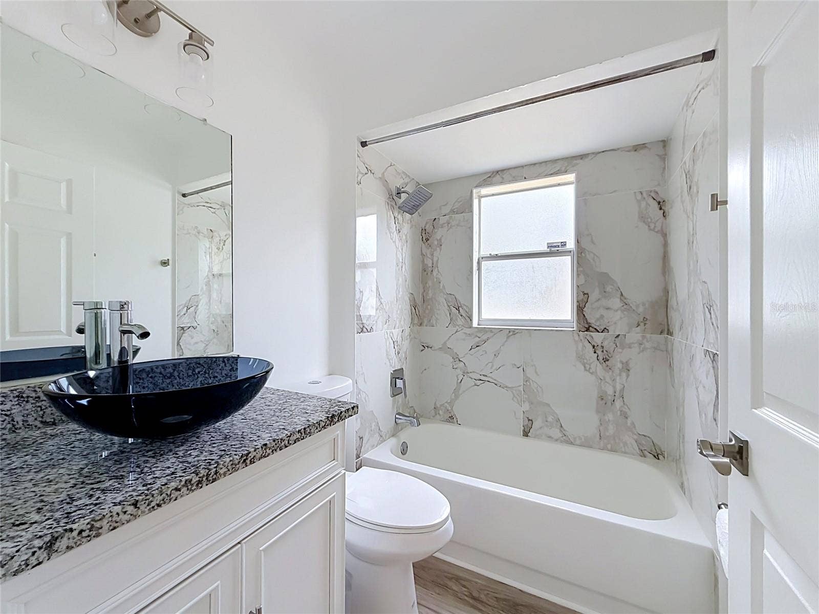 11 CARNATION COURT E, Homosassa, FL 34446 A vessel sink and tub/shower refresh the guest bath.
