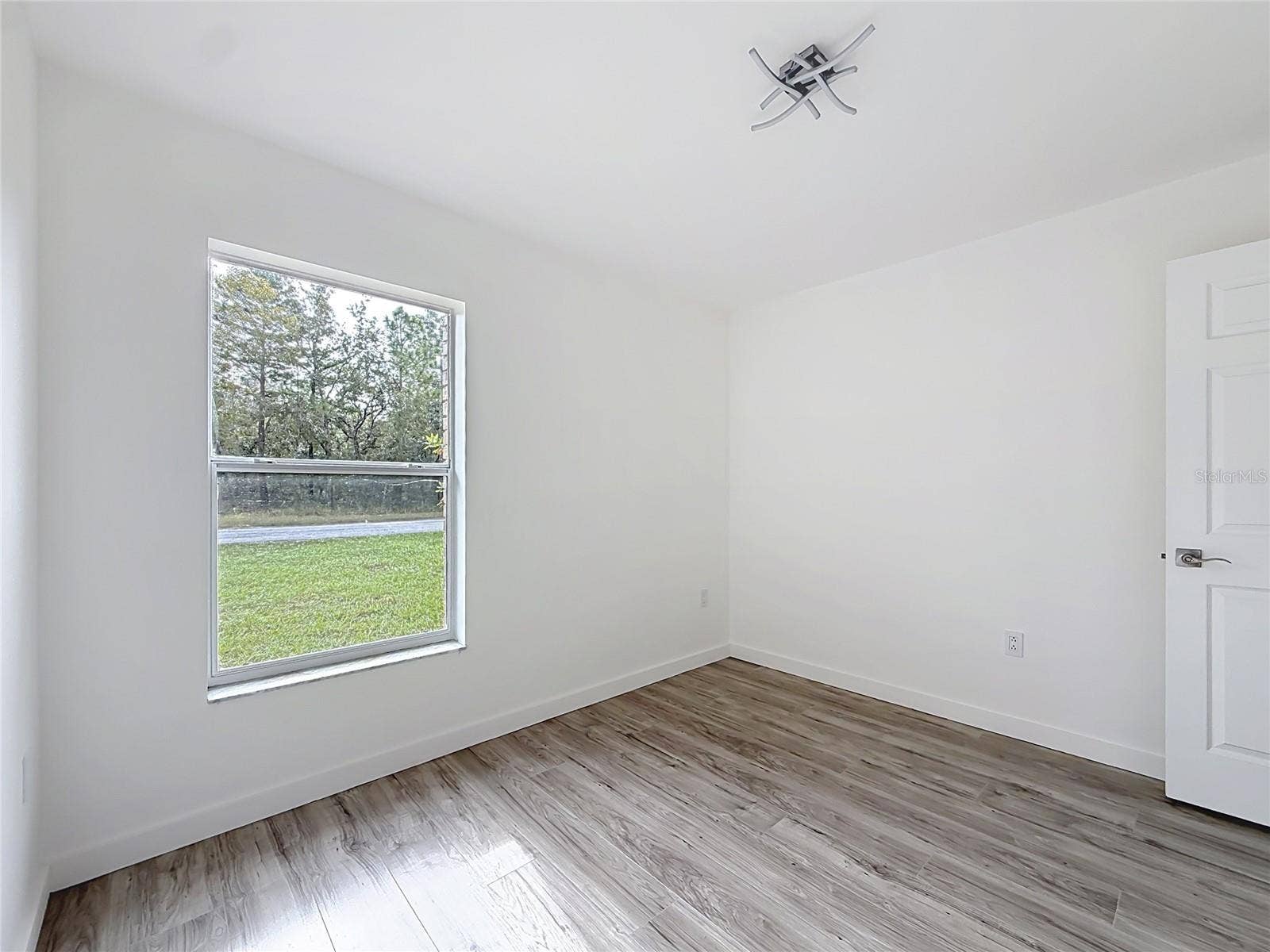 11 CARNATION COURT E, Homosassa, FL 34446 A leafy outlook adds a peaceful touch to this bedroom.