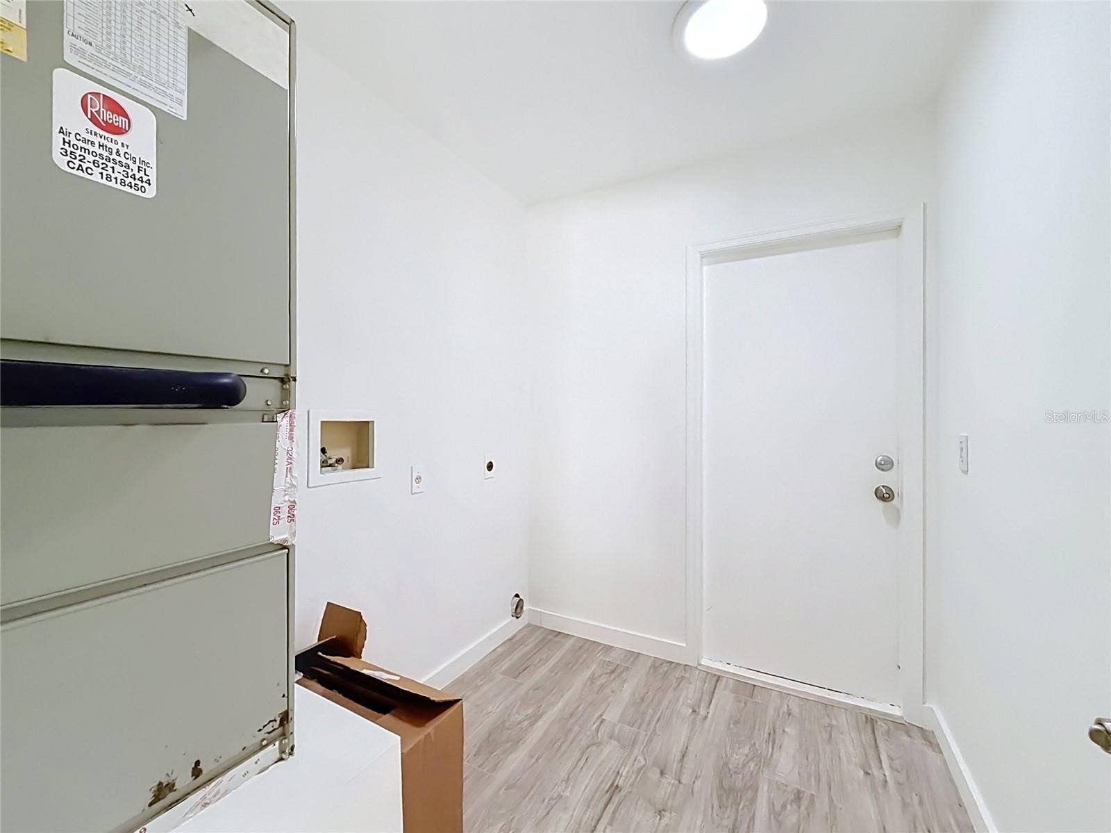 11 CARNATION COURT E, Homosassa, FL 34446 A dedicated laundry area with added storage potential.