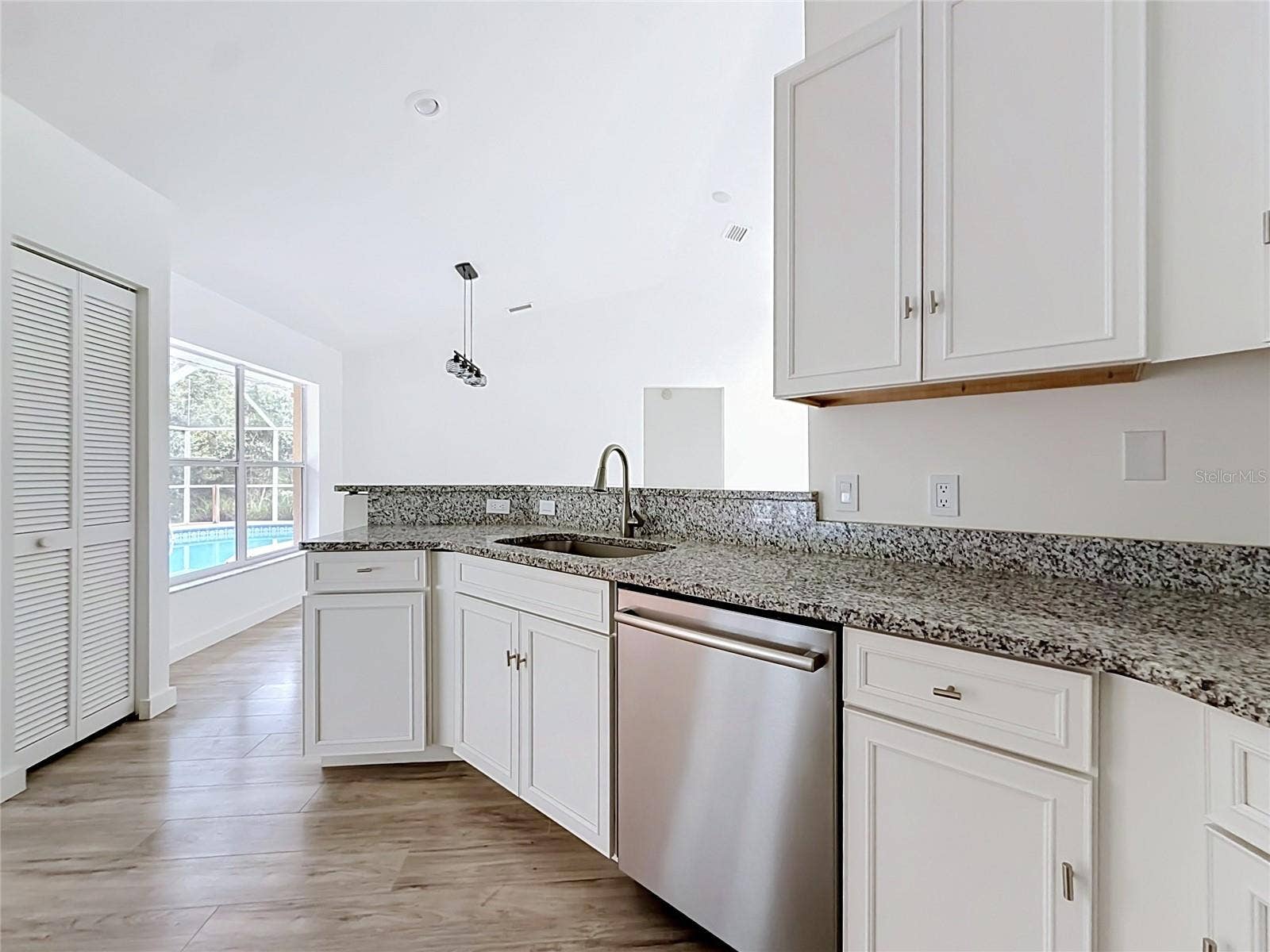 11 CARNATION COURT E, Homosassa, FL 34446 White cabinetry and generous prep space for daily meals.