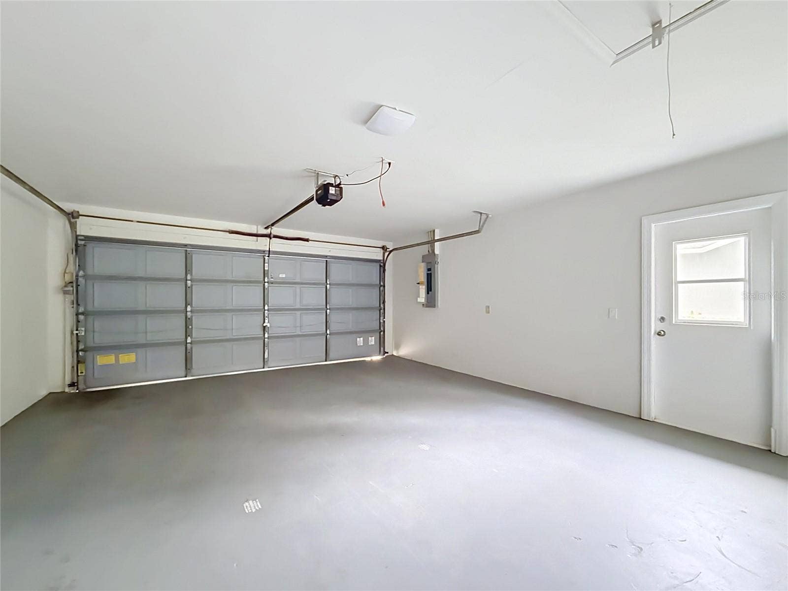 11 CARNATION COURT E, Homosassa, FL 34446 Two-car garage with room for parking and storage.