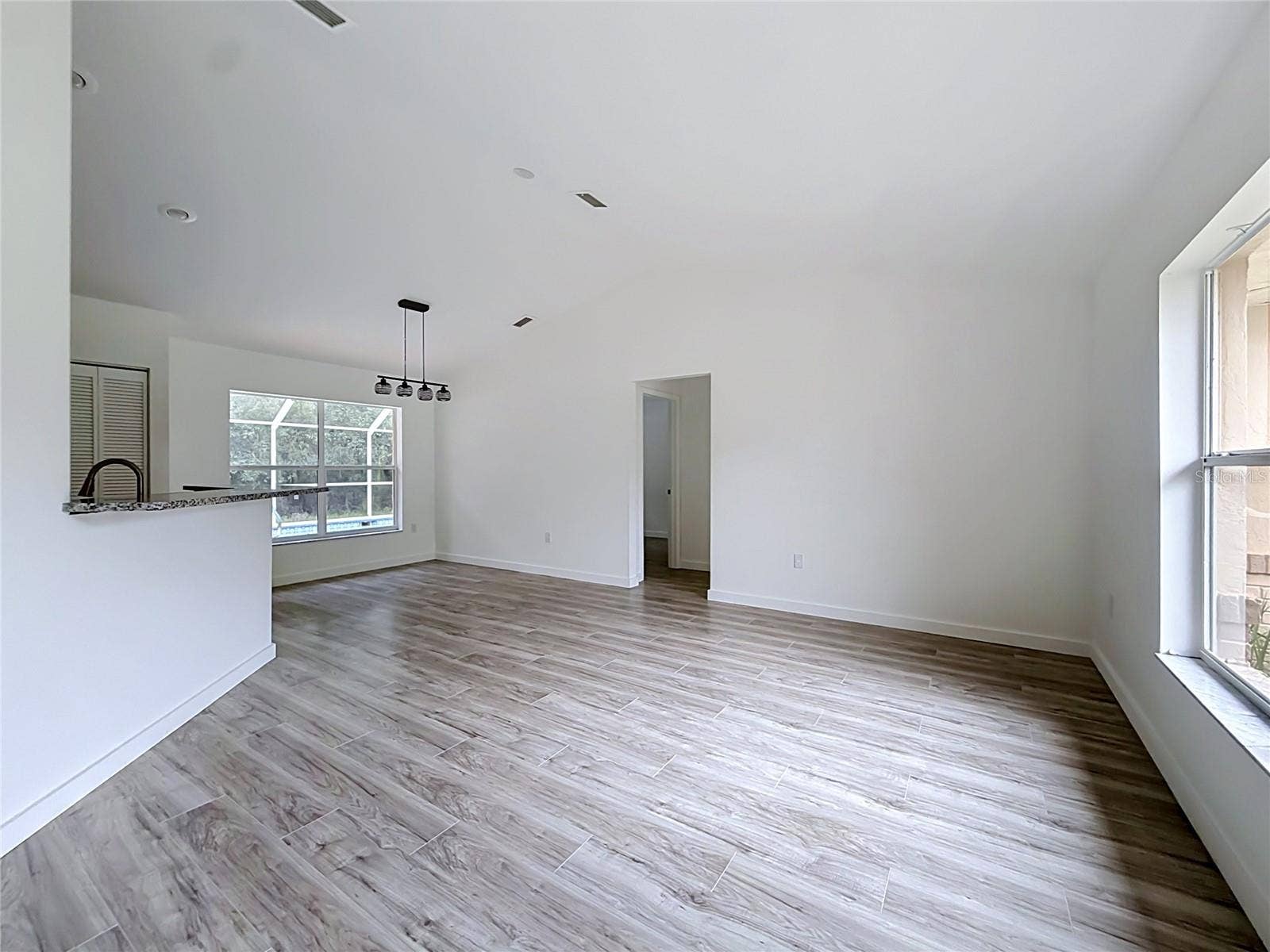 11 CARNATION COURT E, Homosassa, FL 34446 Vaulted ceilings give the living area an airy feel.