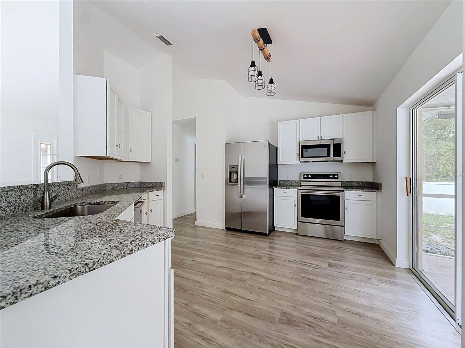 11 CARNATION COURT E, Homosassa, FL 34446 A bright kitchen with easy access to outdoor dining.
