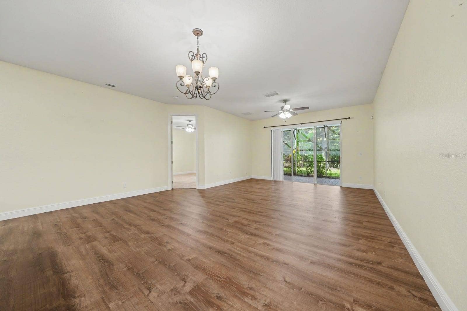 Spacious Living Room With Wood Flooring And Sliding Glass Patio Doors