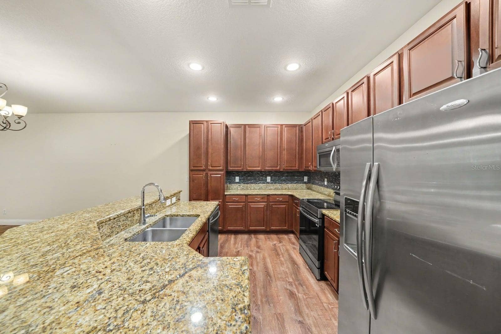 Gourmet Kitchen With Granite Counters, Island Seating & Stainless Appliances