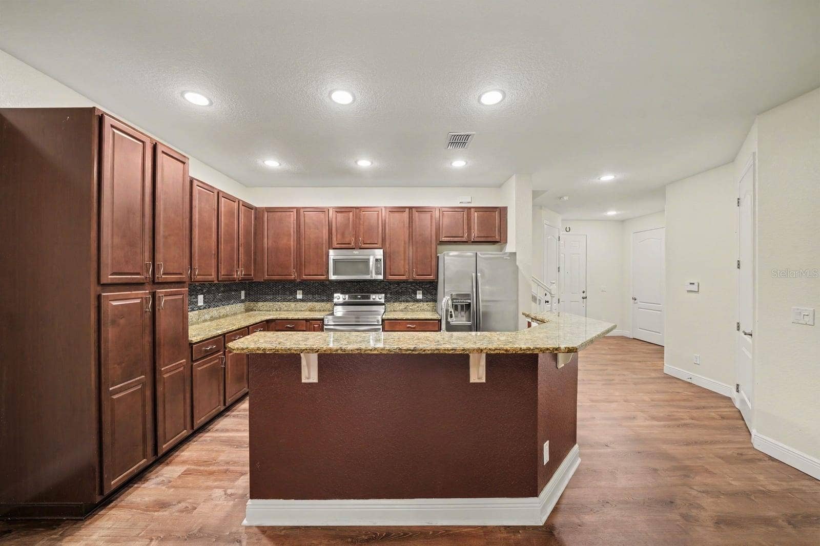 Spacious Kitchen With Island, Granite Counters & Stainless Steel Appliances