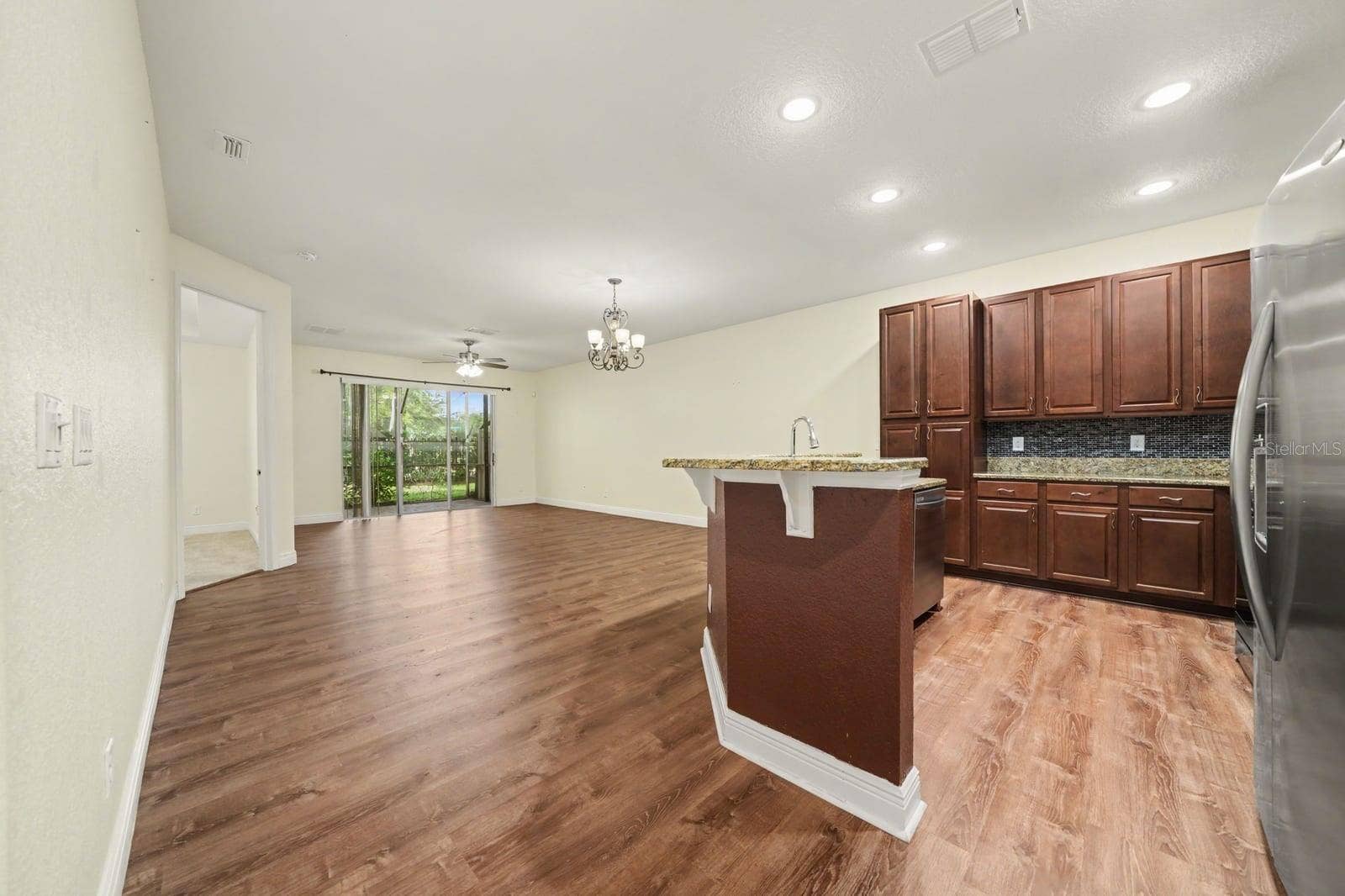Gourmet Kitchen With Dark Cabinetry, Stainless Steel, And Island Workspace