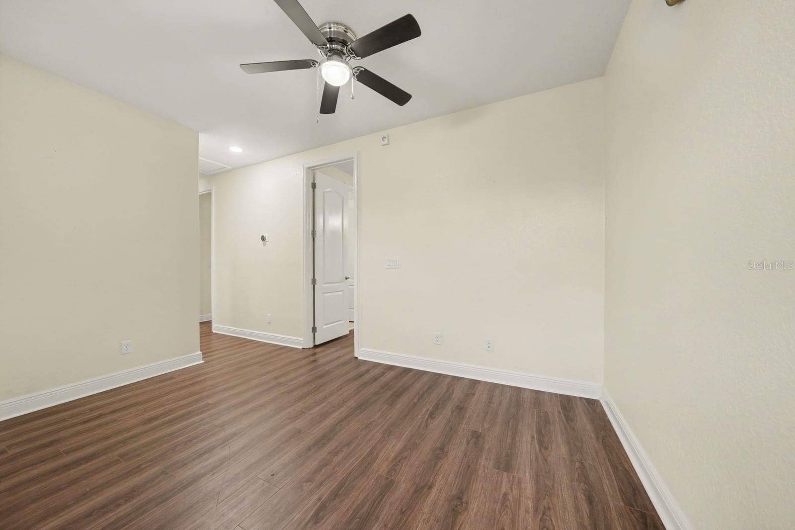Bright Bedroom with Laminate Flooring and Ceiling Fan