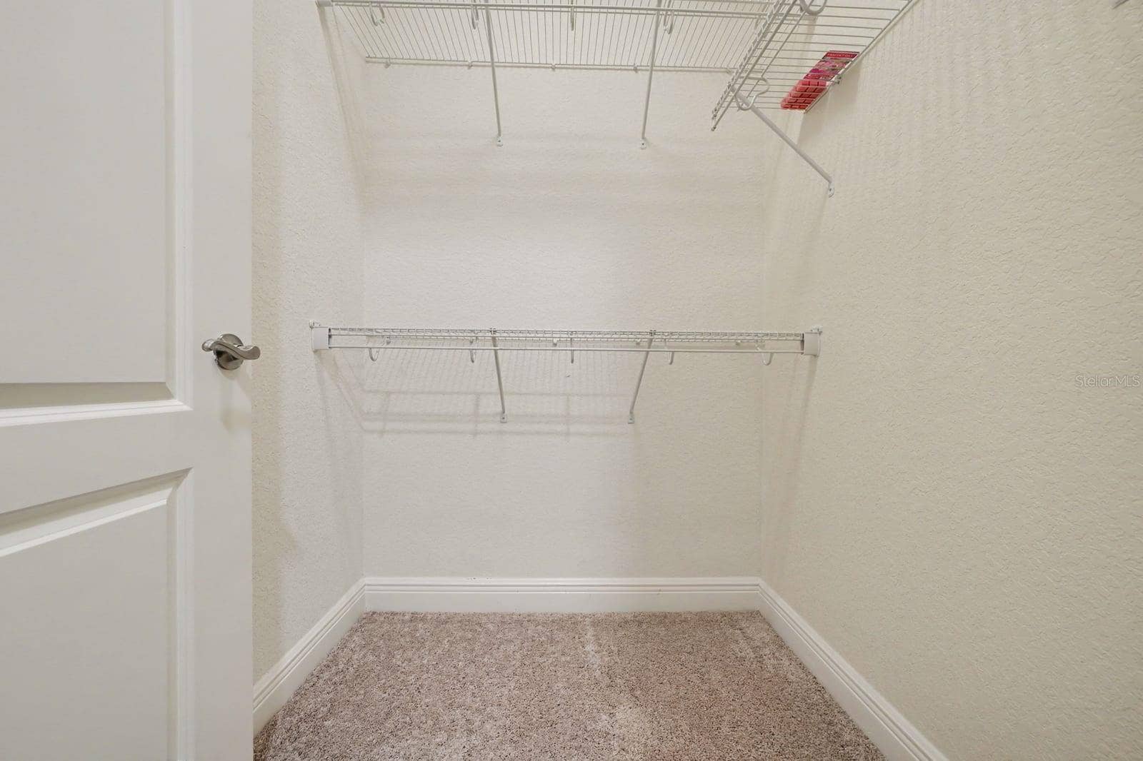 Walk-In Closet with Wire Shelving and Storage Space