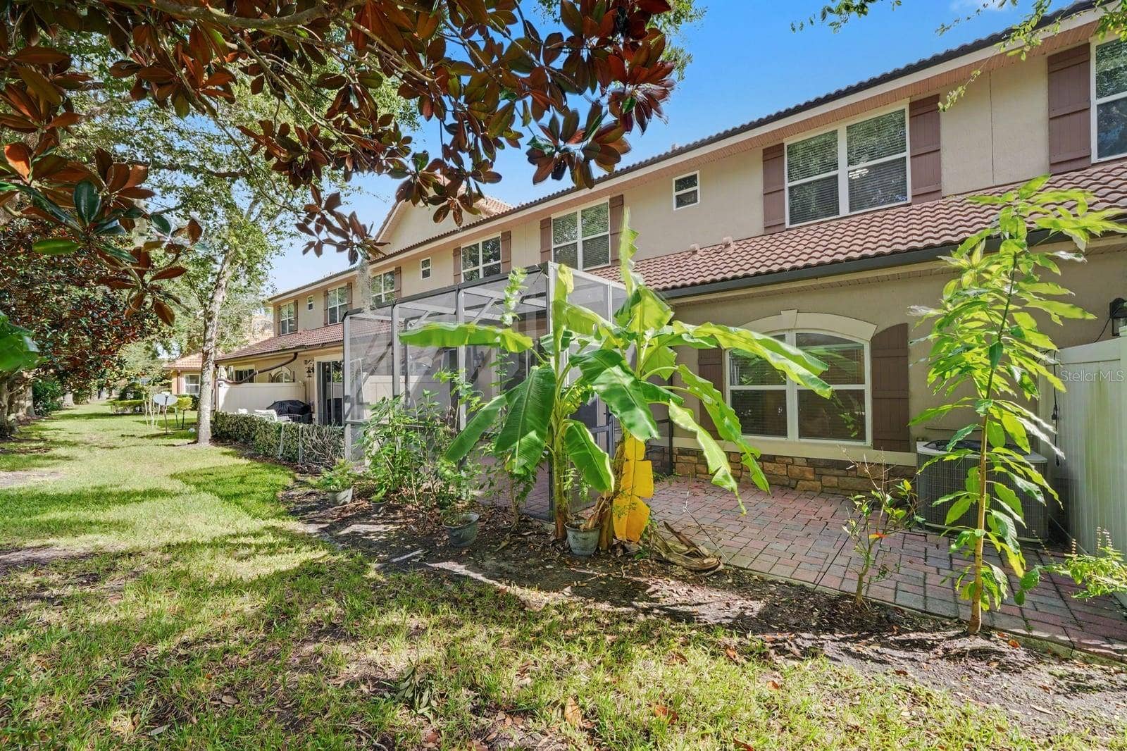 Rear Yard With Established Trees And Screened Pool Area
