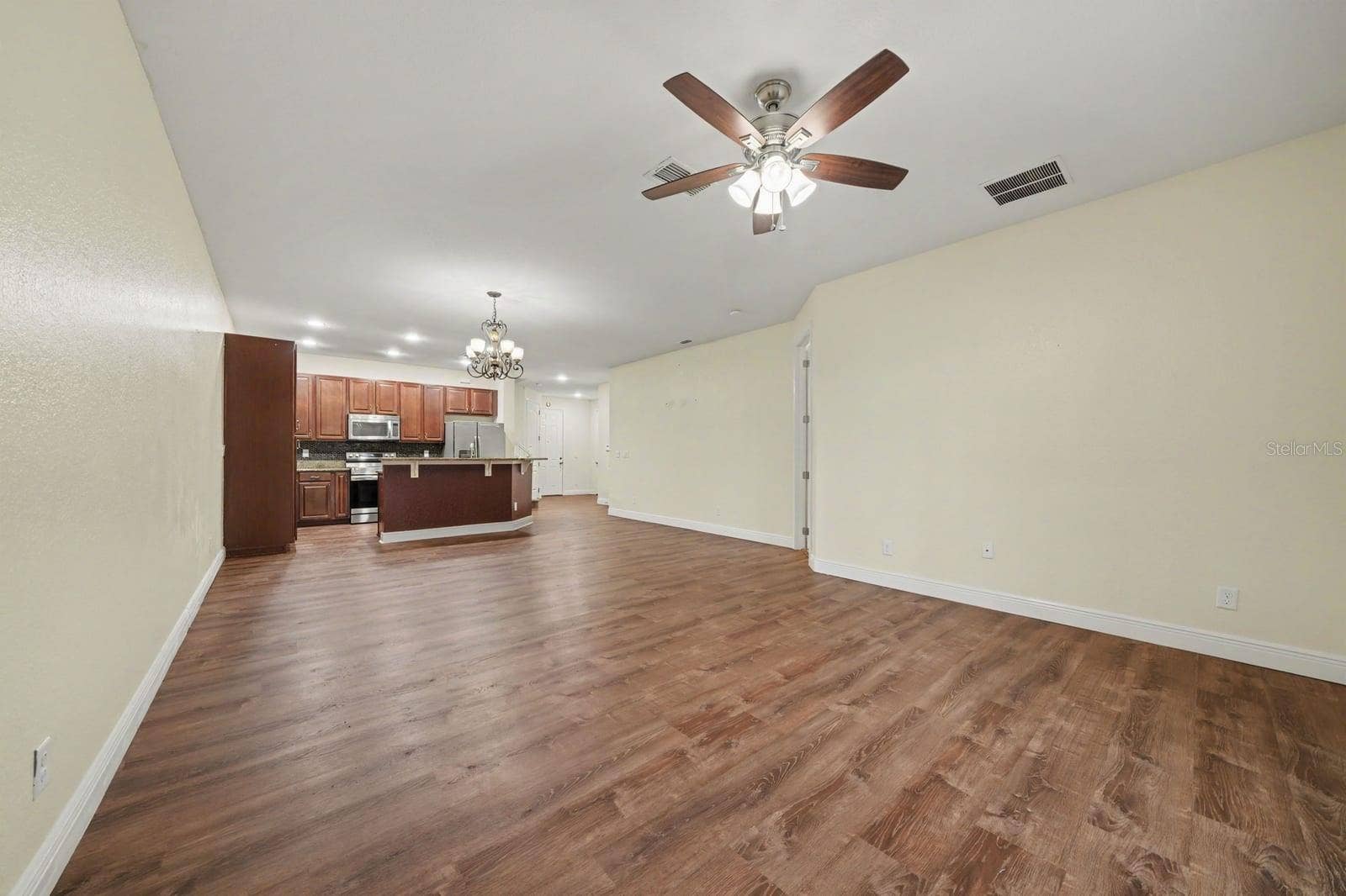 Open Concept Kitchen & Living Area With Rich Wood Flooring