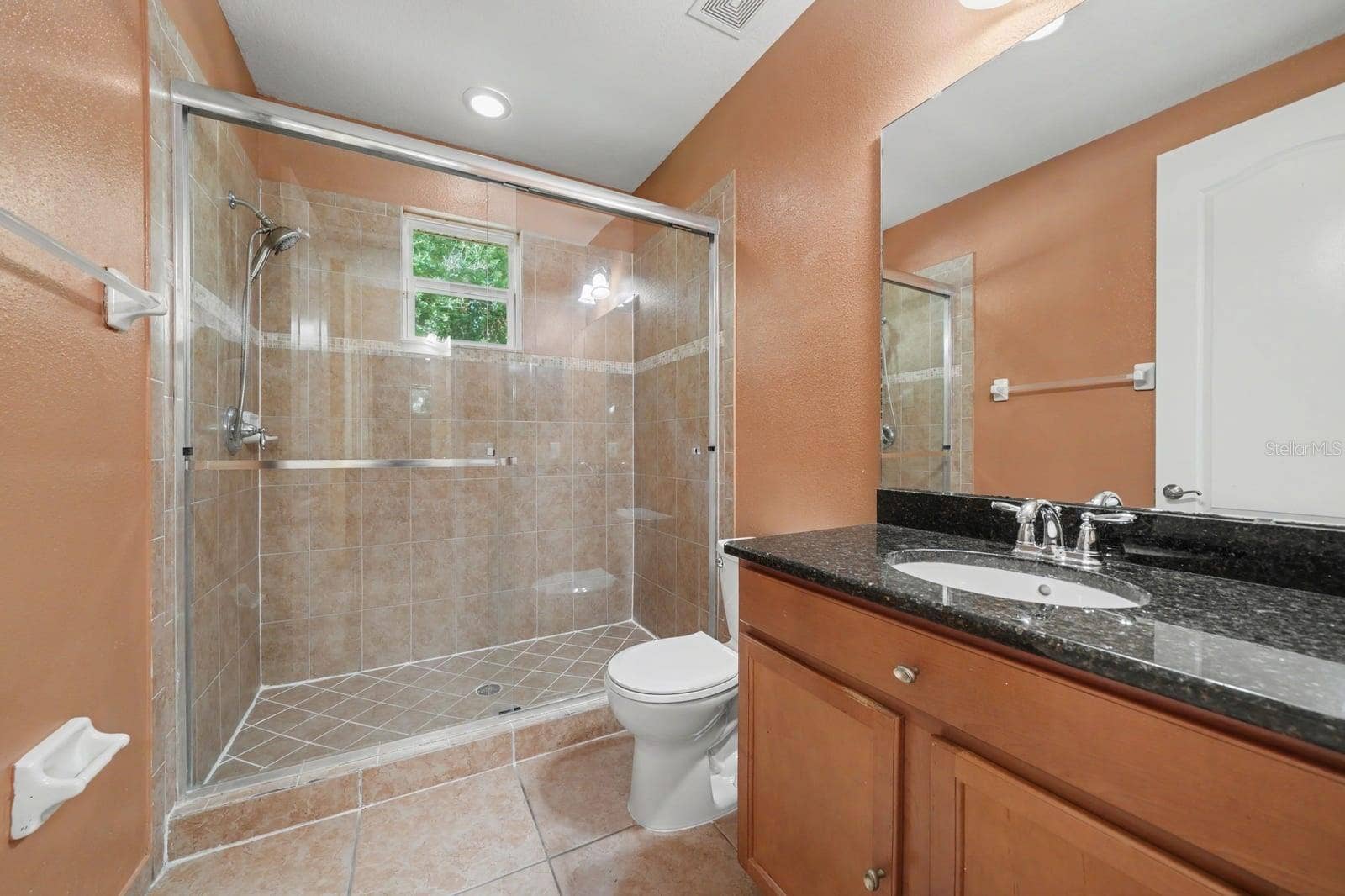 Spa-Like Master Bath with Frameless Shower, Granite Countertops & Warm Tones