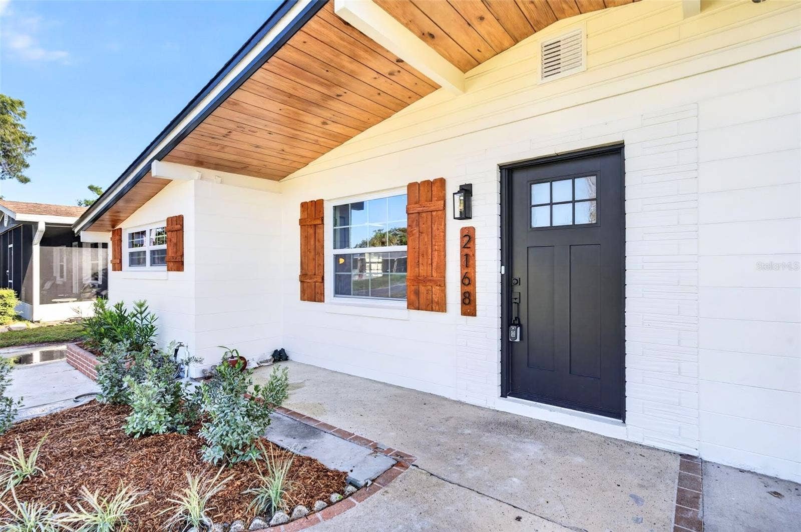 2168 RIDGE DRIVE, Winter Park, FL 32792 Take a look at the tongue and groove soffits and the wooden shutters for that pop of color.