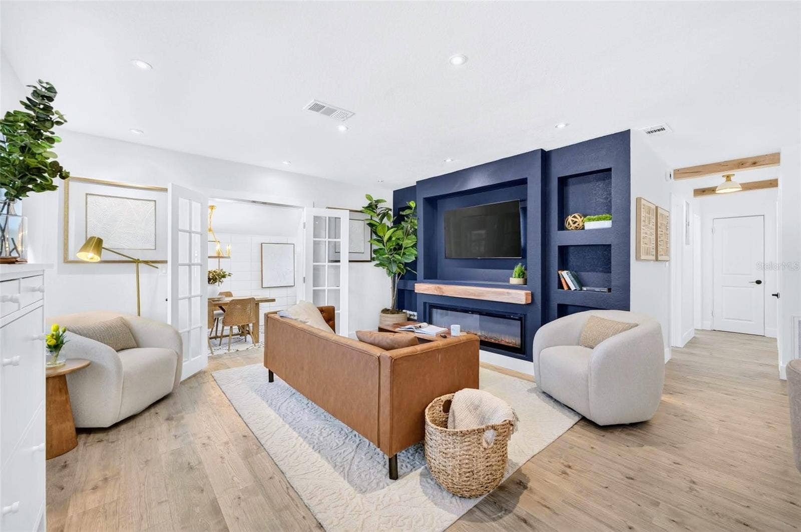 2168 RIDGE DRIVE, Winter Park, FL 32792 upon entry your greeted with warm floors and a blue splash of color on the entertainment wall.