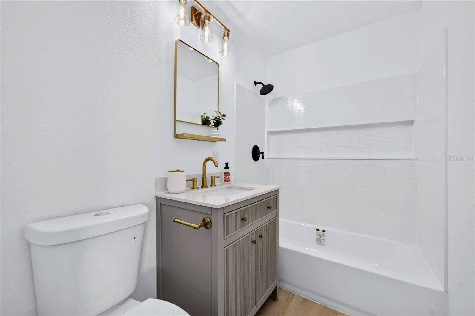 2168 RIDGE DRIVE, Winter Park, FL 32792 This bathroom has the easy to clean/maintain shower surround, with the shelf for multiple bottles of shampoo and hair products.