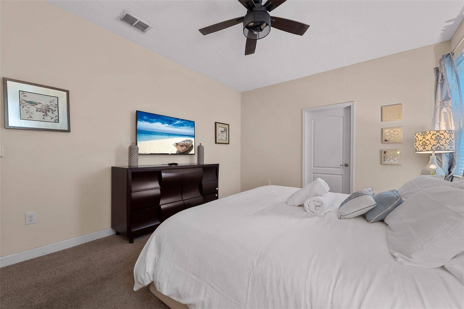 First-Floor Primary Suite with King Bed, Ceiling Fan and Flat-Screen Television