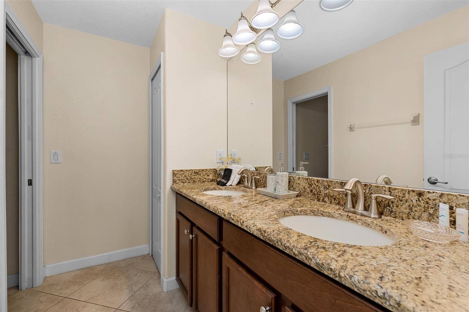 Guest Bathroom Featuring Granite Countertops, Double Vanity and Generous Counter Space