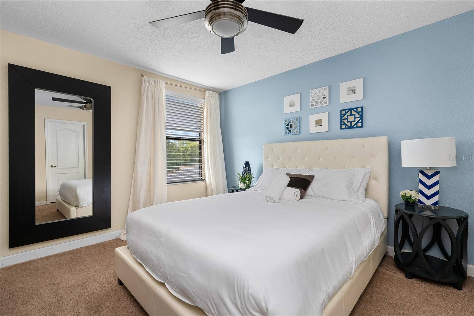 Comfortable Guest Bedroom with Queen Bed and Soft Blue Accents