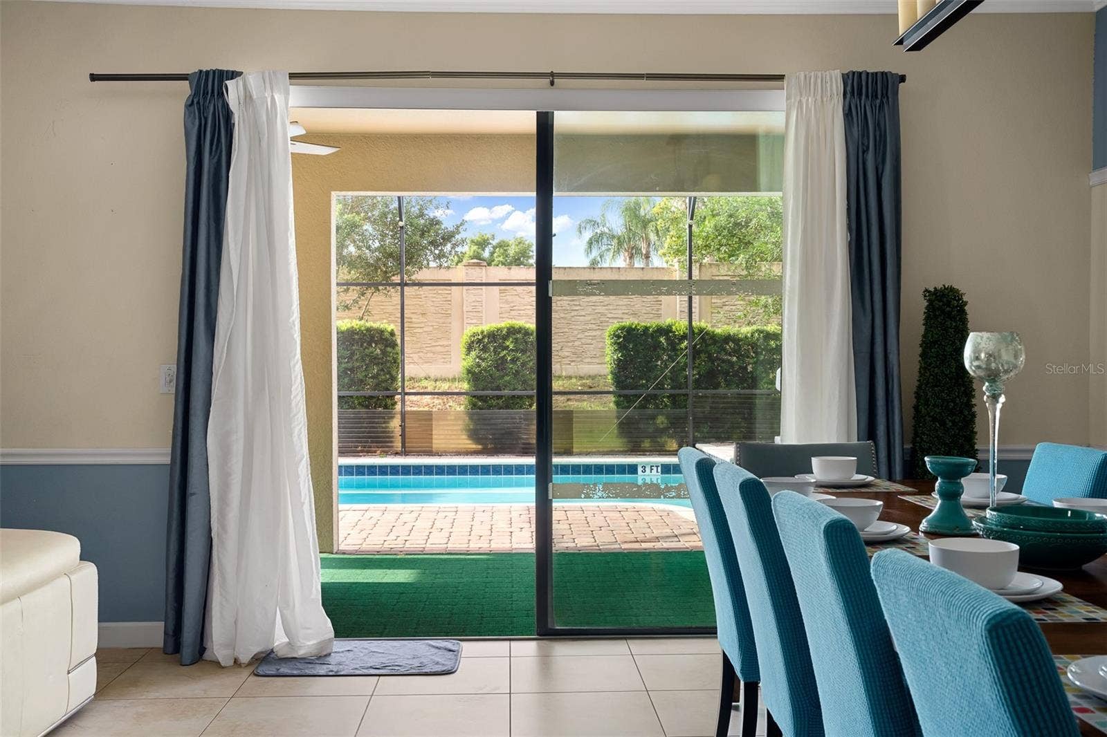 Indoor-Outdoor Living Made Easy with Sliding Glass Doors Opening to the Poolside Retreat