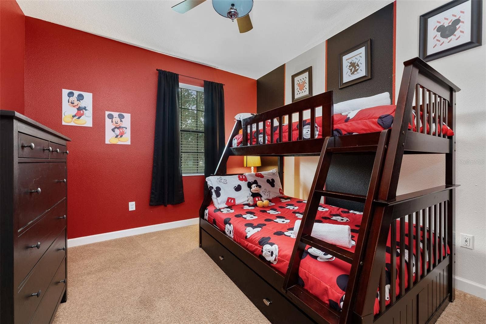 Mickey-Themed Bedroom with Playful Red Accents and Twin-Over-Full Bunk Bed