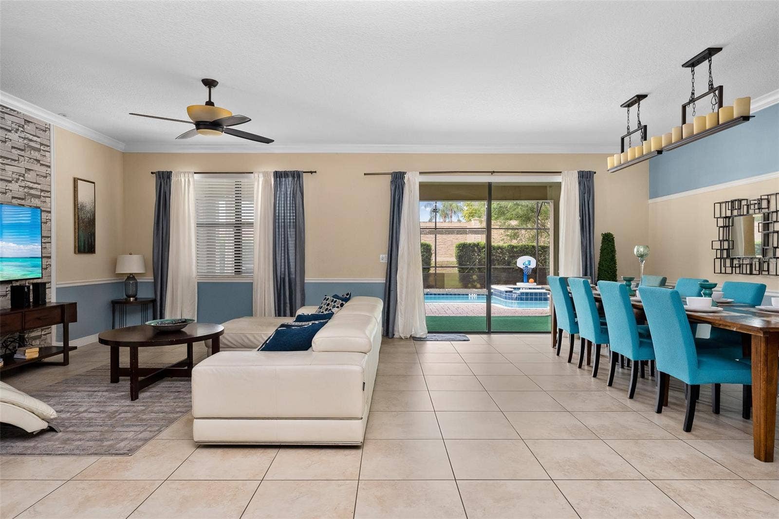 Seamless Open-Concept Living Connects the Kitchen, Dining and Family Room with Views Toward the Pool