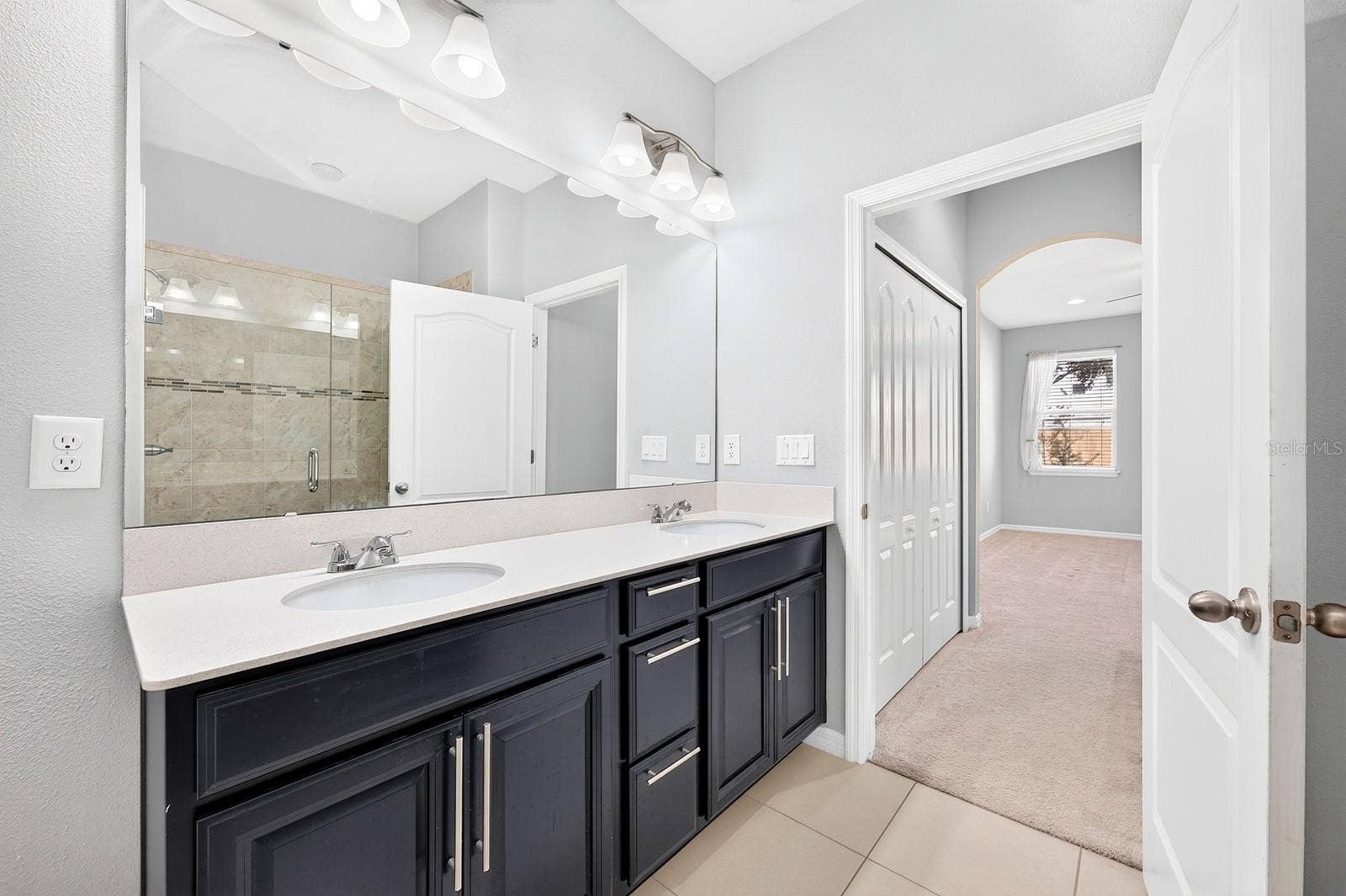 2128 LENNOX DALE LANE, Brandon, FL 33510 The private Bath features dual sinks, a STEP-IN SHOWER and a linen closet for additional storage.