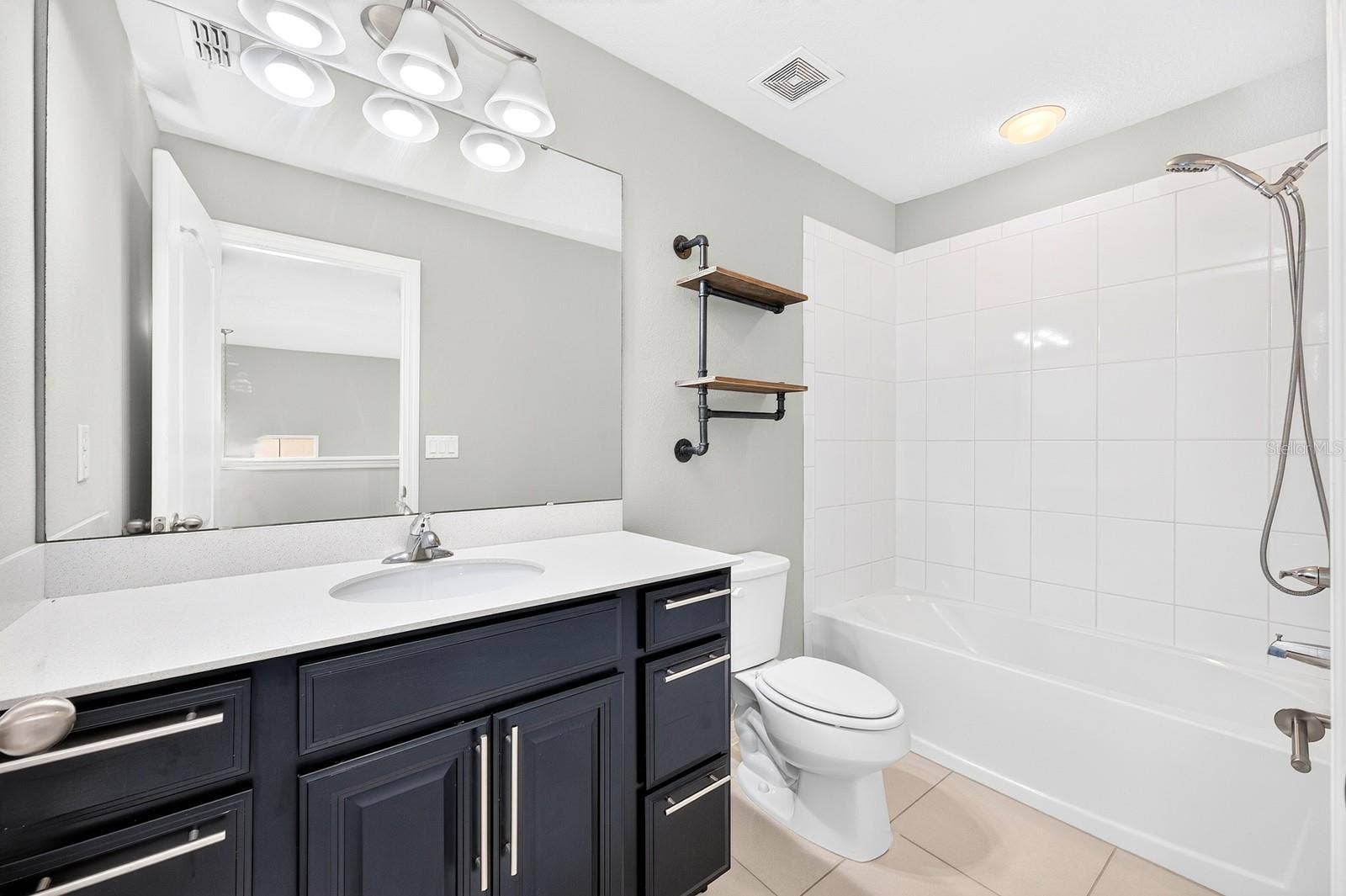 2128 LENNOX DALE LANE, Brandon, FL 33510 The upstairs full Bath continues the home's stylish finishes, featuring a QUARTZ COUNTERTOP that complements the matching countertops in both main-floor Bathrooms.