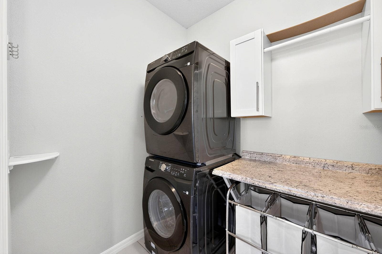 2128 LENNOX DALE LANE, Brandon, FL 33510 A DEDICATED LAUNDRY ROOM on the first floor includes a GRANITE FOLDING COUNTER and cabinetry to keep everything organized.