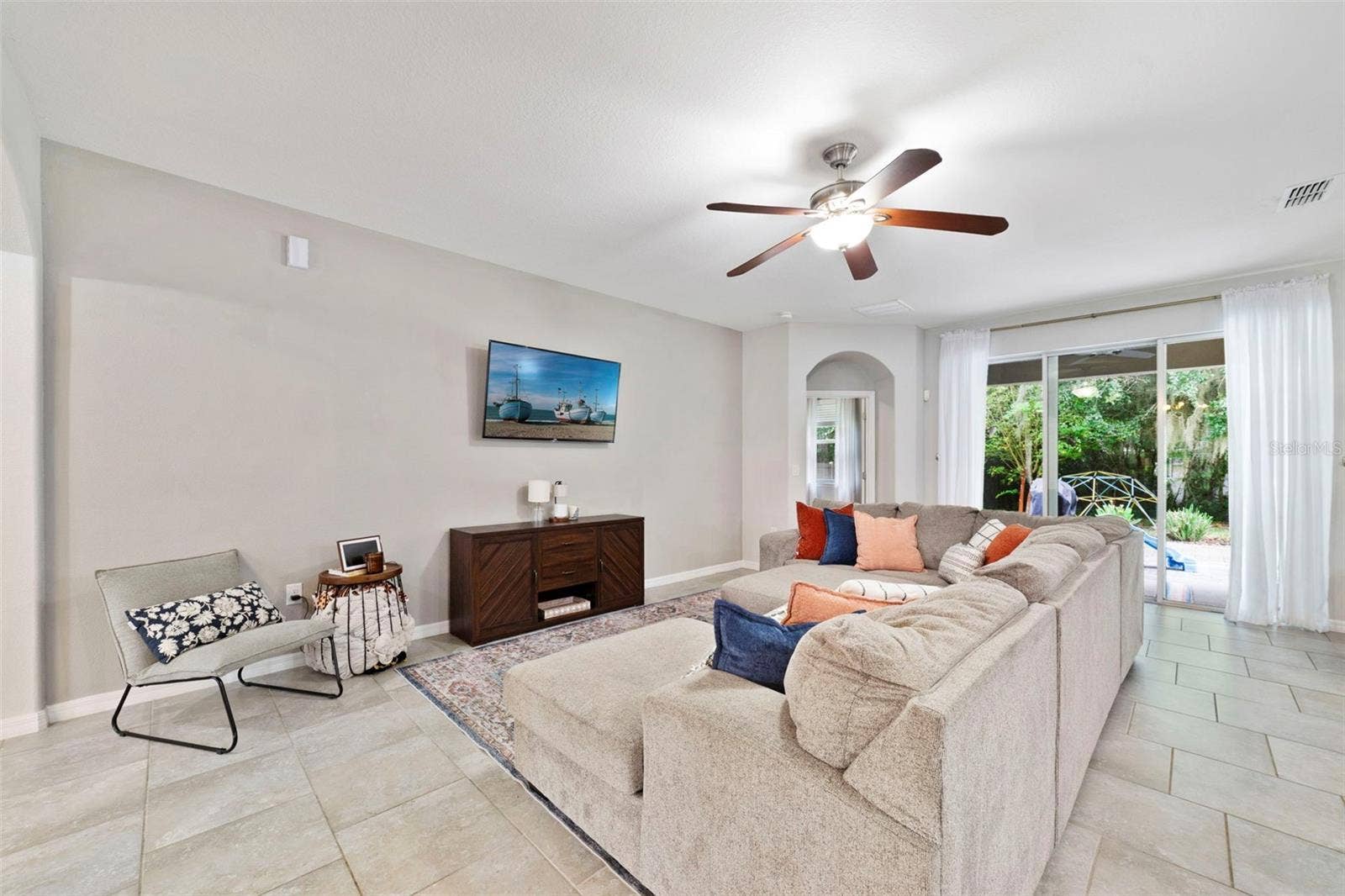 611 MEADOW SAGE DRIVE, Deland, FL 32724 Living area has triple sliding glass doors that open up to the lanai.