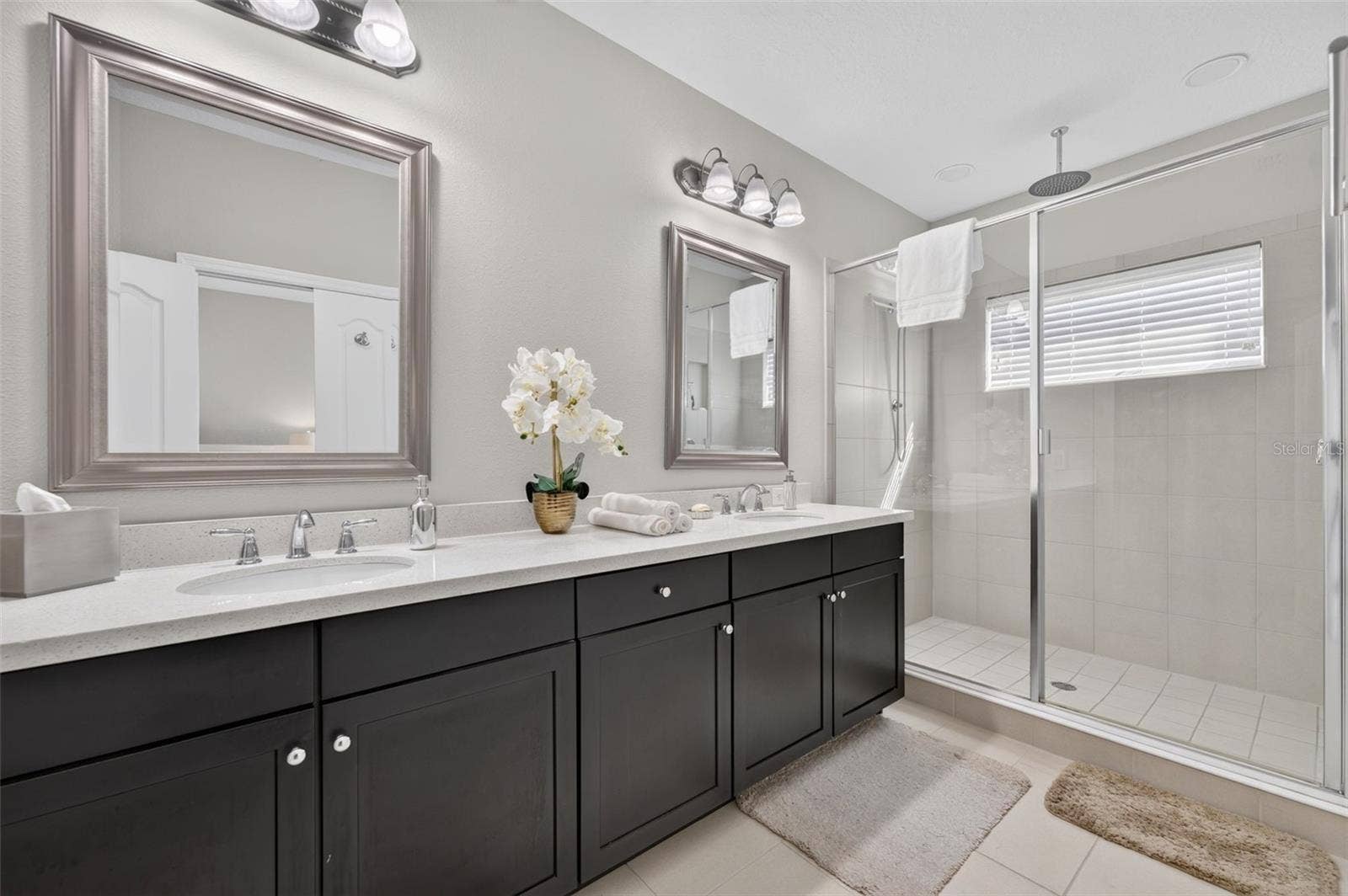716 GRADO POINT, Oviedo, FL 32765 Primary Bathroom features stone counters, tall cabinetry, 2 sinks and an oversized shower