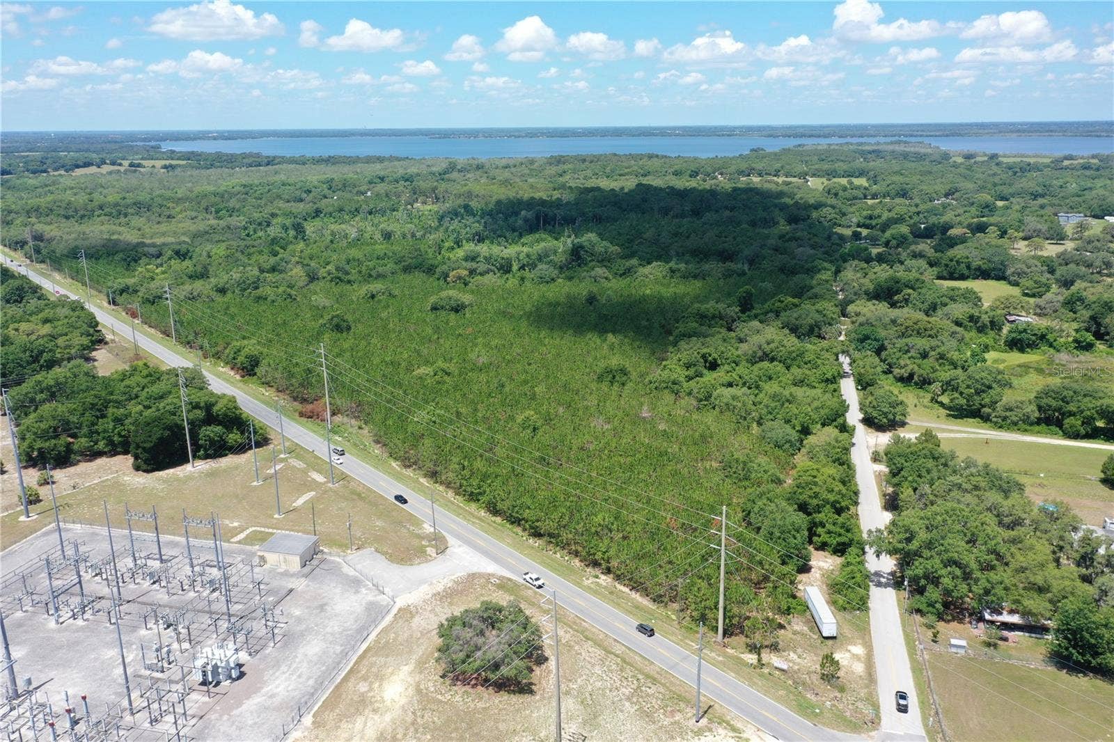 9300 E TREASURE ISLAND AVENUE, Leesburg, FL 34788 An aerial photo of the site from the northeastern corner, oriented southwest.