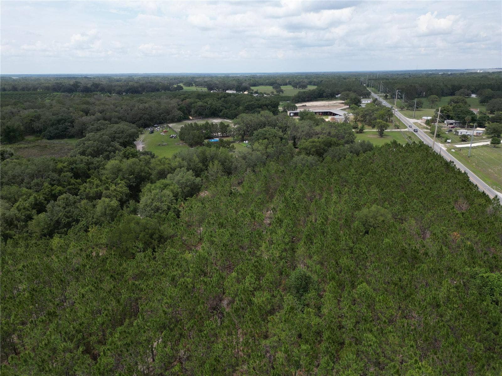 9300 E TREASURE ISLAND AVENUE, Leesburg, FL 34788 An aerial photo of the site from the northeastern corner, oriented northeast.