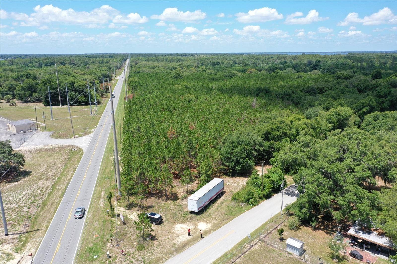 9300 E TREASURE ISLAND AVENUE, Leesburg, FL 34788 An aerial photo of the site from the northeastern corner, oriented southwest.